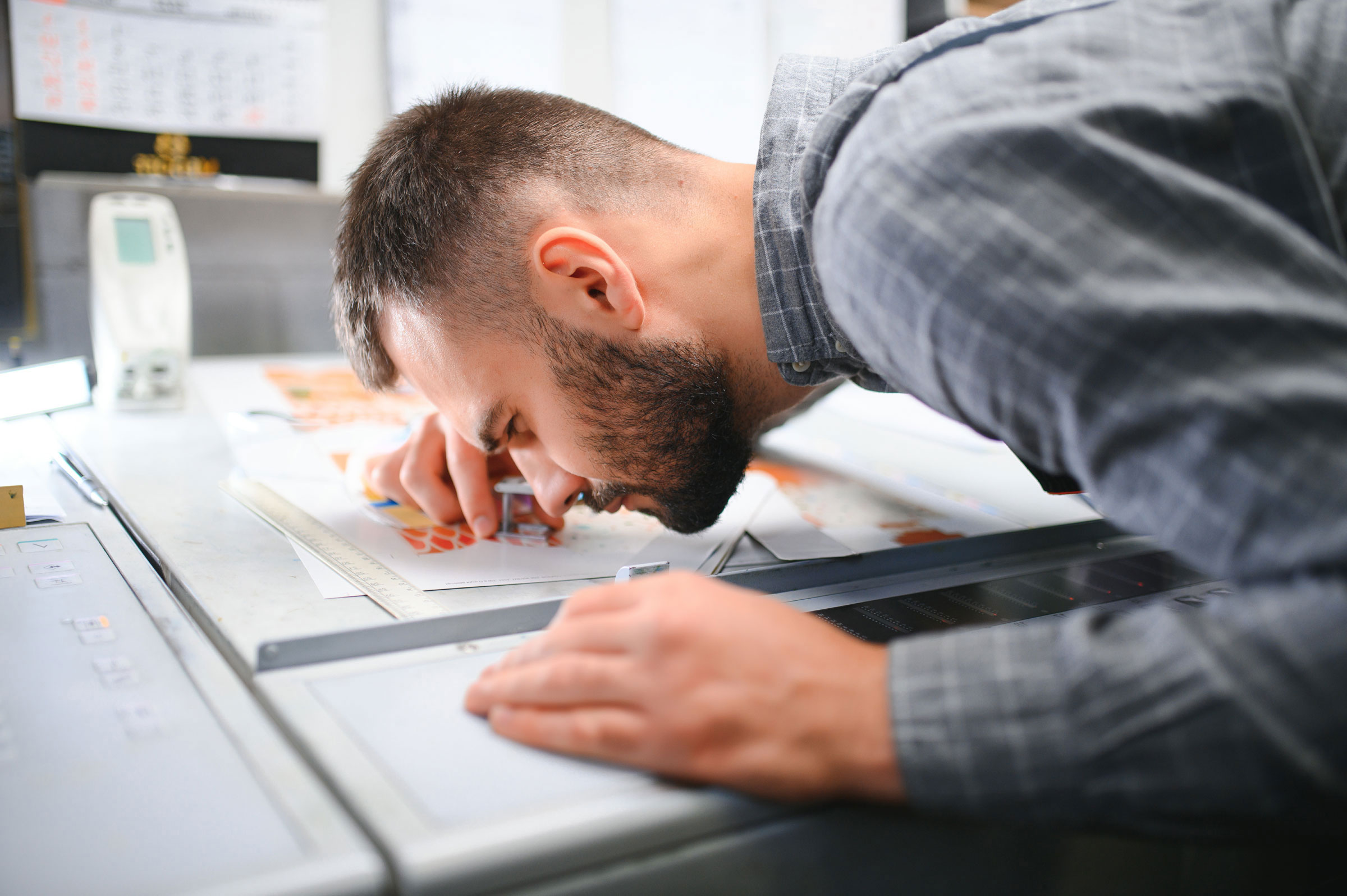 print operator inspecting quality